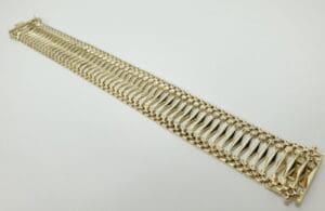 Gold bracelet with intricate link design.