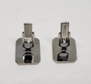 Two silver rectangular cufflinks on display.