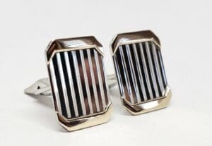 Silver cufflinks with vertical striped design.