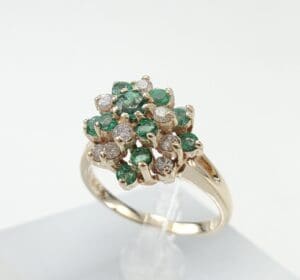 Gold ring with emeralds and diamonds.