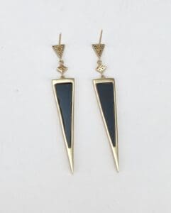 Gold and black triangular drop earrings.
