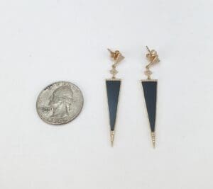 Triangle earrings and quarter for scale.