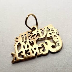 Gold pendant with intricate cut-out design.