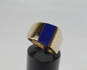 Gold ring with blue stone inset.