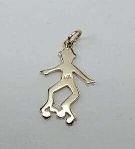 Gold roller skater pendant on white background.