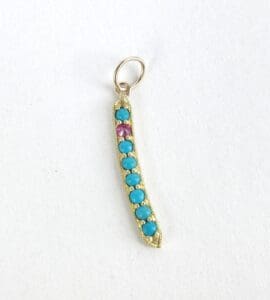 Gold pendant with turquoise and pink stones.