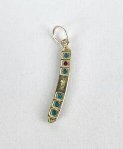 Gold pendant with turquoise and red stones.