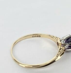 Gold ring with intricate side details.
