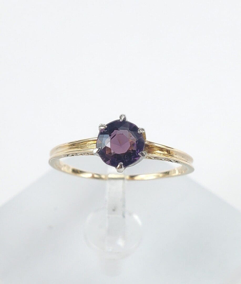 Gold ring with a dark gemstone.