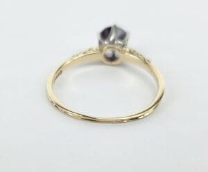 Gold ring with gemstone on white background.