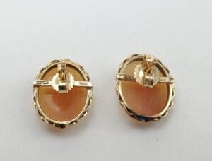 Gold oval clip-on earrings with stone.