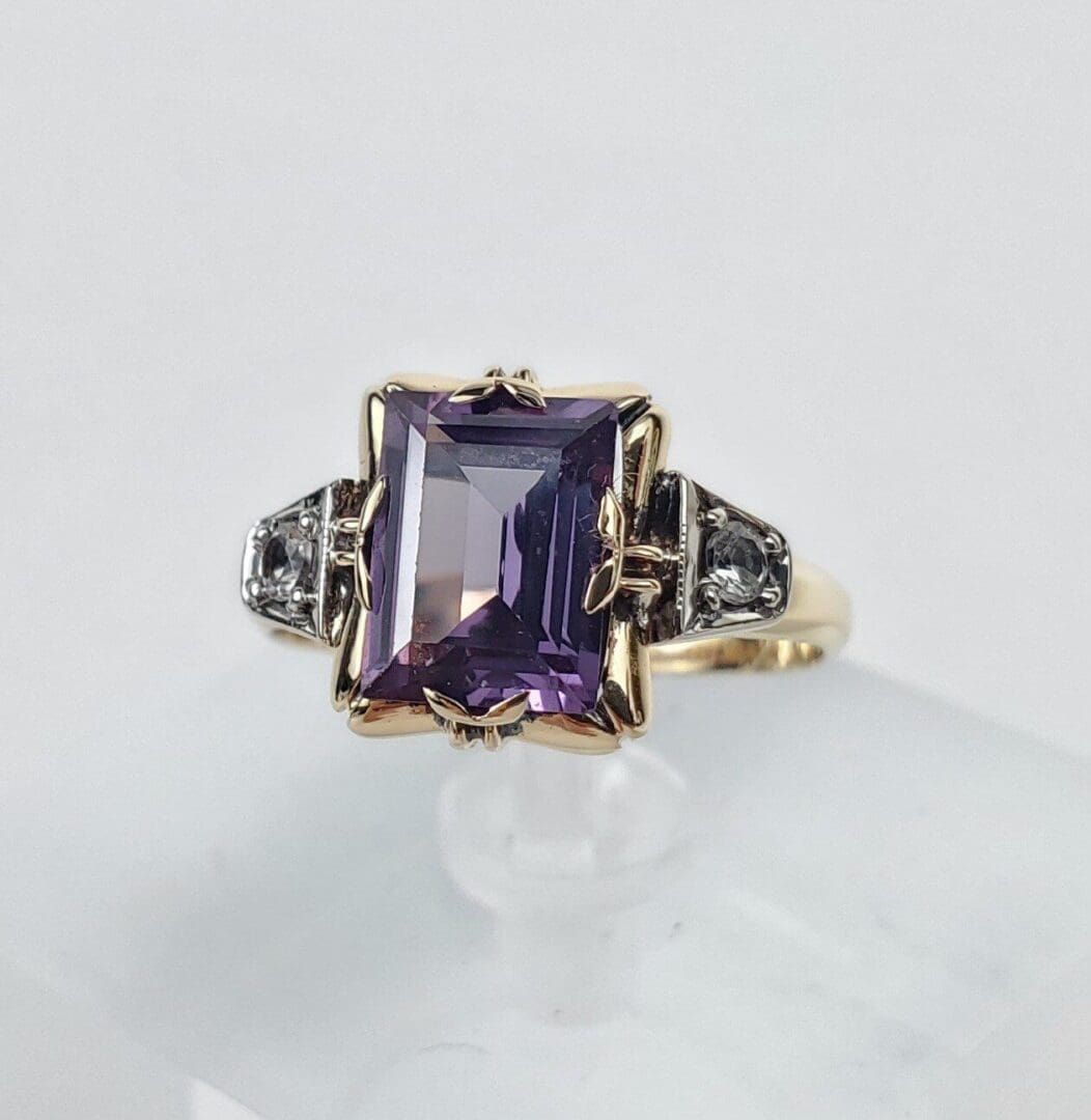Purple gemstone ring with ornate silver accents.
