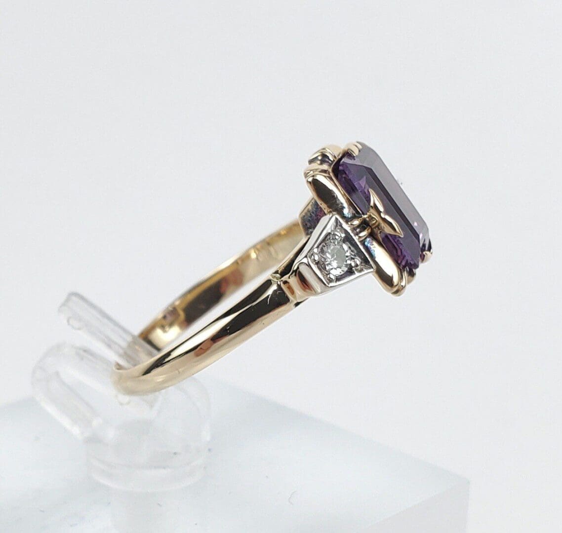 Gold ring with purple gemstone and diamond.