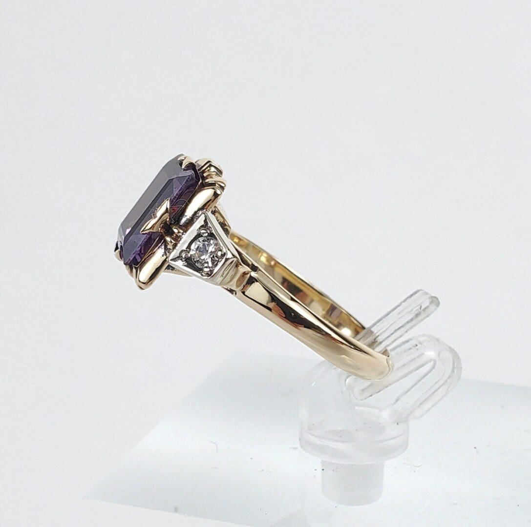 Gold ring with purple gemstone and diamond.