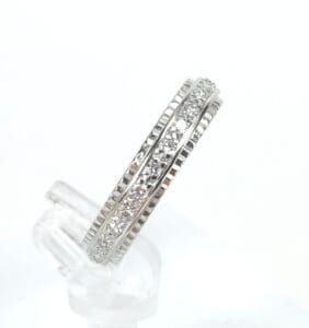 Silver ring with embedded clear stones.