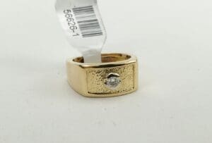 Gold ring with diamond and barcode tag.
