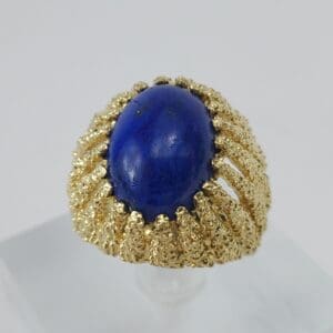 Gold ring with oval blue stone.