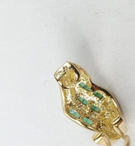 Gold ring with turquoise inlay design.
