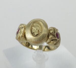 Gold ring with engraved portrait and rubies.