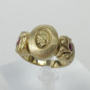Gold ring with engraved portrait and rubies.