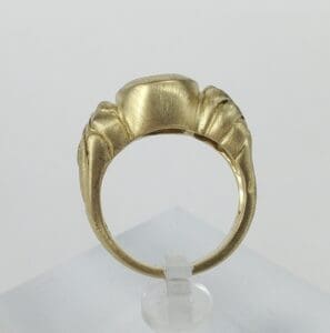 Gold ring with a unique sculpted design.
