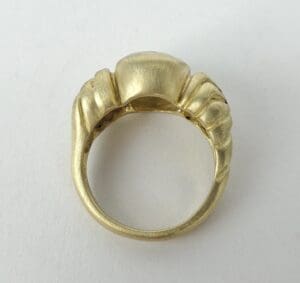 Gold ring with unique, sculpted design.