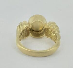 Gold ring with unique design detail.