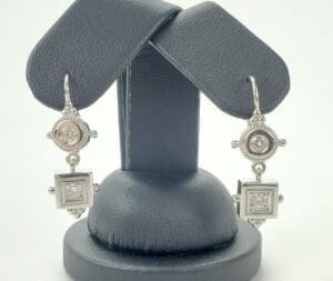 Silver drop earrings with geometric design.