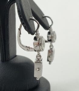 Silver earrings with rectangular dangle design.