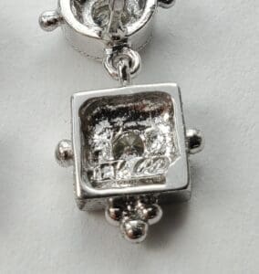 Silver jewelry piece with a gemstone detail.