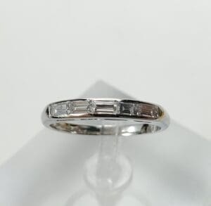 Silver ring with small rectangular diamonds.