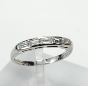 Silver ring with rectangular diamond accents.