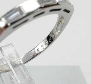 Silver ring with engraved numbers on display.