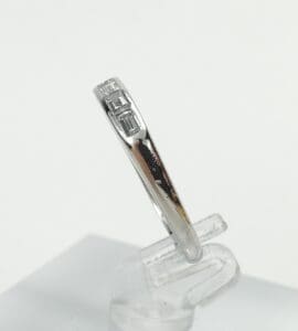 Silver ring with geometric design on display.
