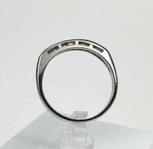 Silver ring with rectangular cutouts displayed upright.
