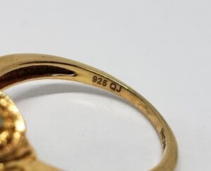 Gold ring with "925 QJ" marking.