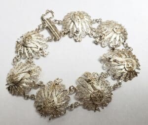 Silver filigree bracelet with peacock design.