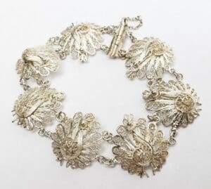 Intricate silver bracelet with floral designs.