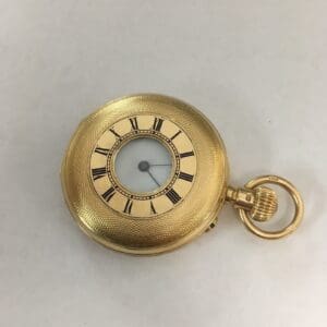 Gold pocket watch with Roman numerals.