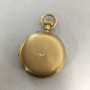 Gold pocket watch on a white background.