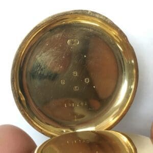Gold pocket watch case with hallmarks inside.