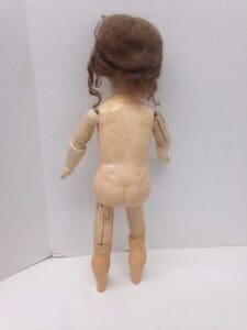 Back view of a vintage wooden doll.
