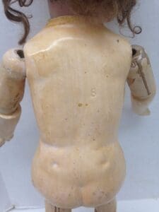 Back view of vintage doll with curls.