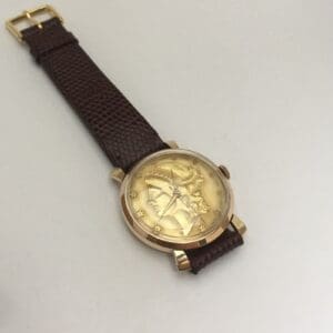 Gold watch with brown leather strap.