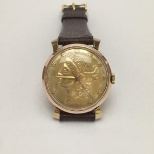 Gold watch with embossed warrior design.