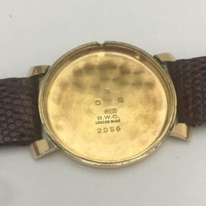 Back of a vintage gold watch case.