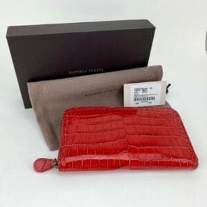 Red leather wallet with box and pouch.