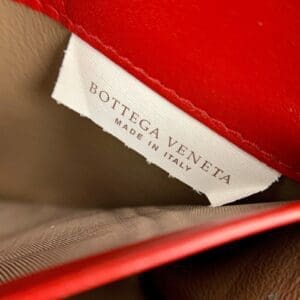 Label inside red Bottega Veneta bag.
