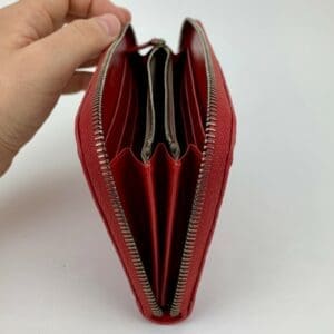 Red zippered wallet with multiple compartments.