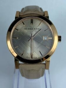 Gold Burberry watch with leather strap.